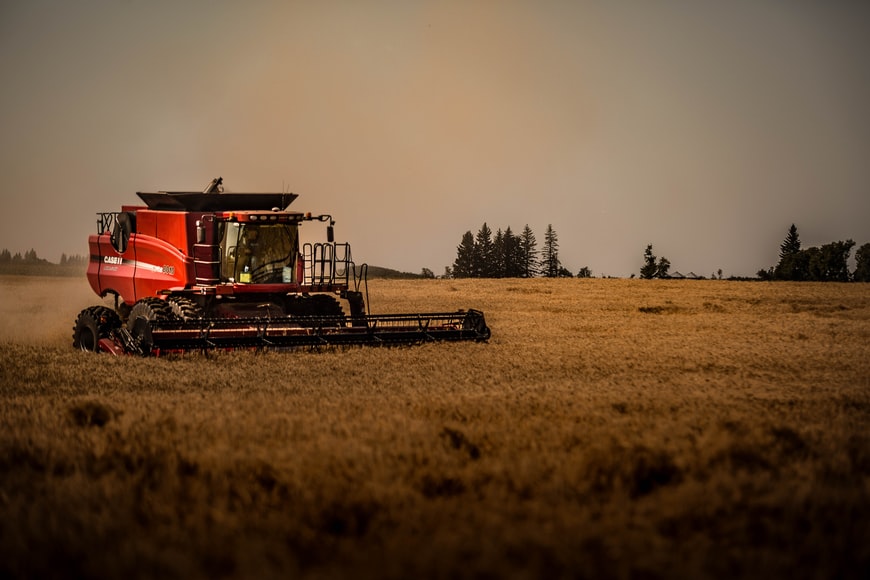 Image of red and black train on a brown farm for sale in Canada