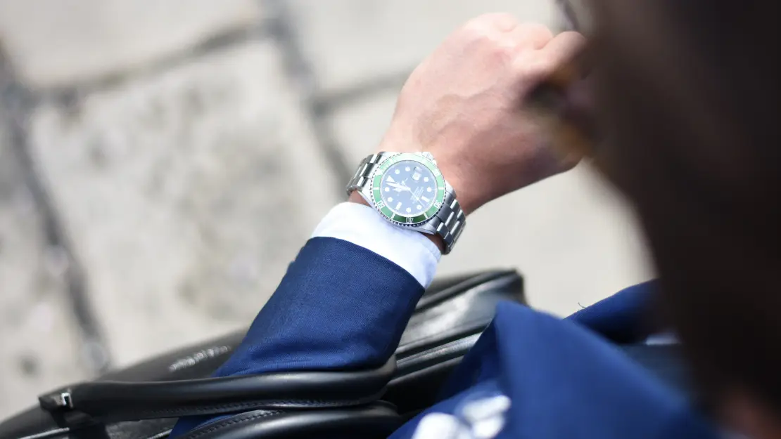 Image of a person selling their business checking the time