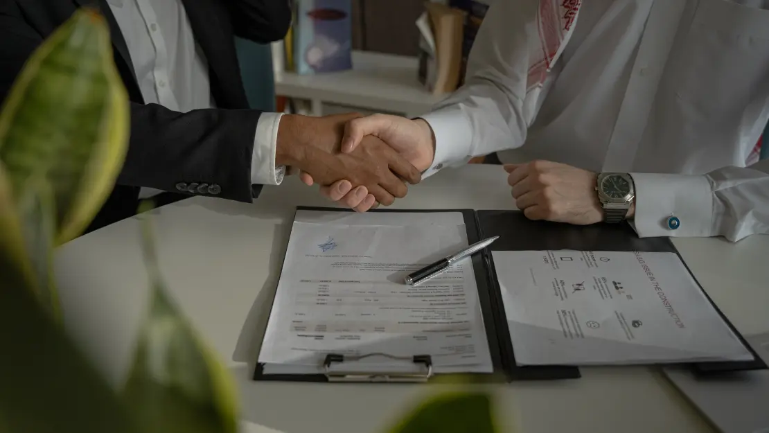 Image of a person shaking hands and selling their business in Canada