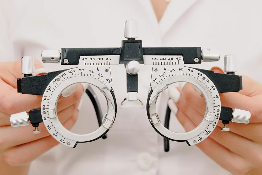 Image of an optometrist holding a trial frame at an optometry practice for sale in Canada