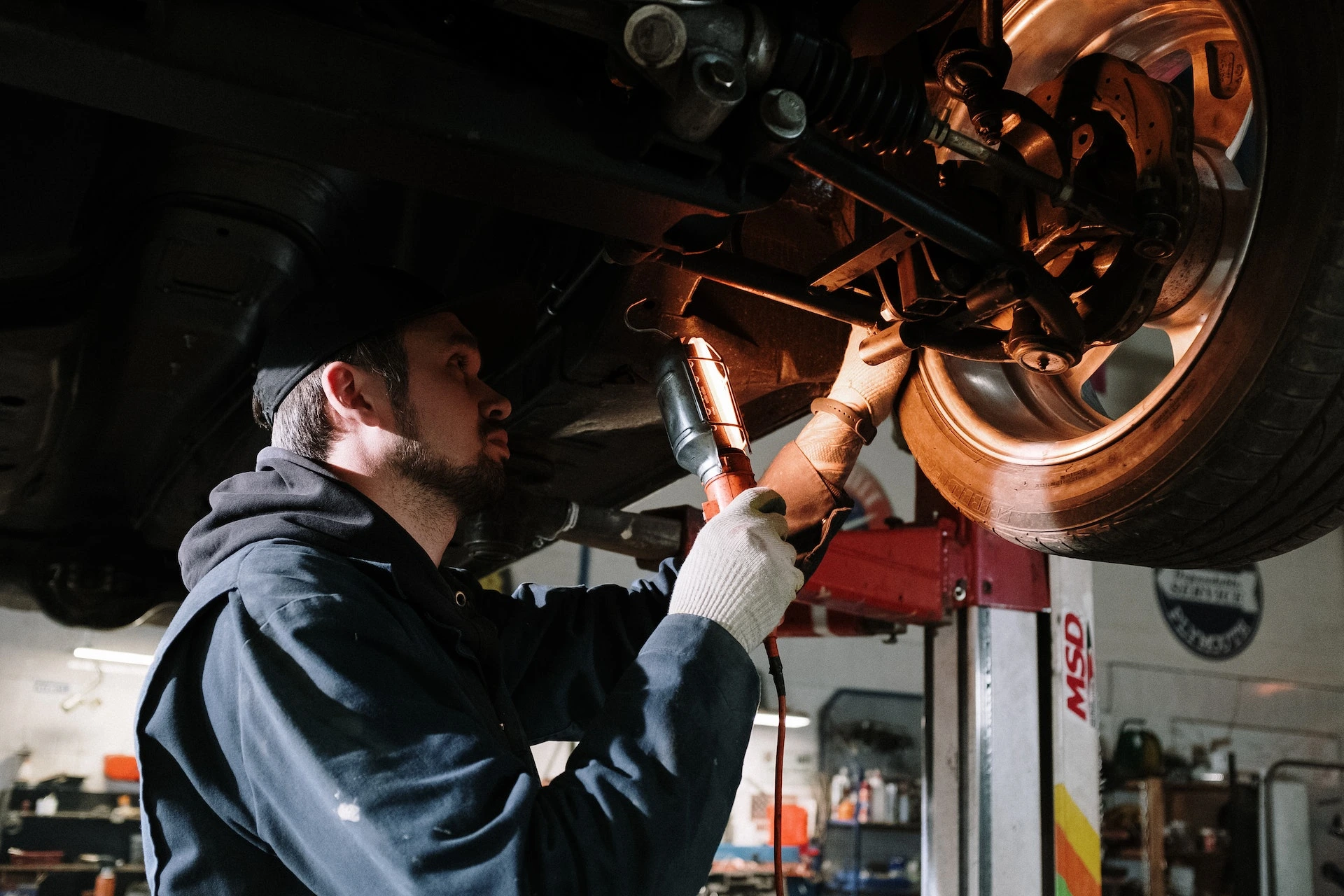 Image of an auto mechanic fixing a tire in an auto repair shop for sale in Canada