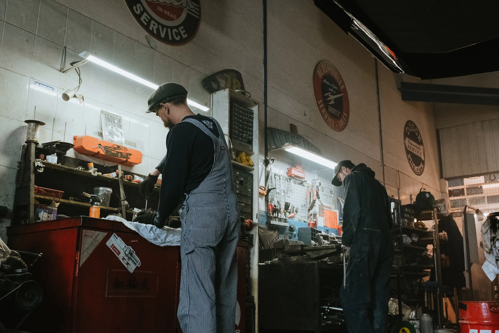 Image of two mechanics fixing auto parts in an auto repair shop for sale in Canada